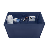 A navy blue fabric organizer box with multiple interior pockets, shown holding various items including a white bottle, a small tube, a pair of sunglasses, and a silver smartphone. The box is photographed on a clean white background.
#color_oxford navy