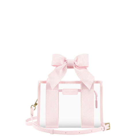 A light pink transparent tote bag with a large matching fabric bow on top, pink webbing handles, a thin shoulder strap, and small gold-tone hardware, shown on a plain white background.
#color_ballet pink bow