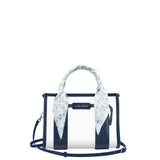 A Case-Mate structured handbag with navy blue and white vertical stripes, featuring a light blue and white floral silk scarf tied to the top handle, set against a plain white background.
#color_something navy twilly