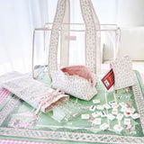 Set of white and pink bags with mohjong tiles and racks on a green mat #color_quilted ditsy floral