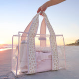 A woman on the beach showing her quilted ditsy floral jelly tote bag