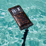 Phone with tortoiseshell waterproof floating pouch submerged in water #color_tortoiseshell