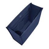 A navy blue fabric organizer insert with multiple internal compartments, shown from an elevated angle on a solid white background.
#color_oxford navy