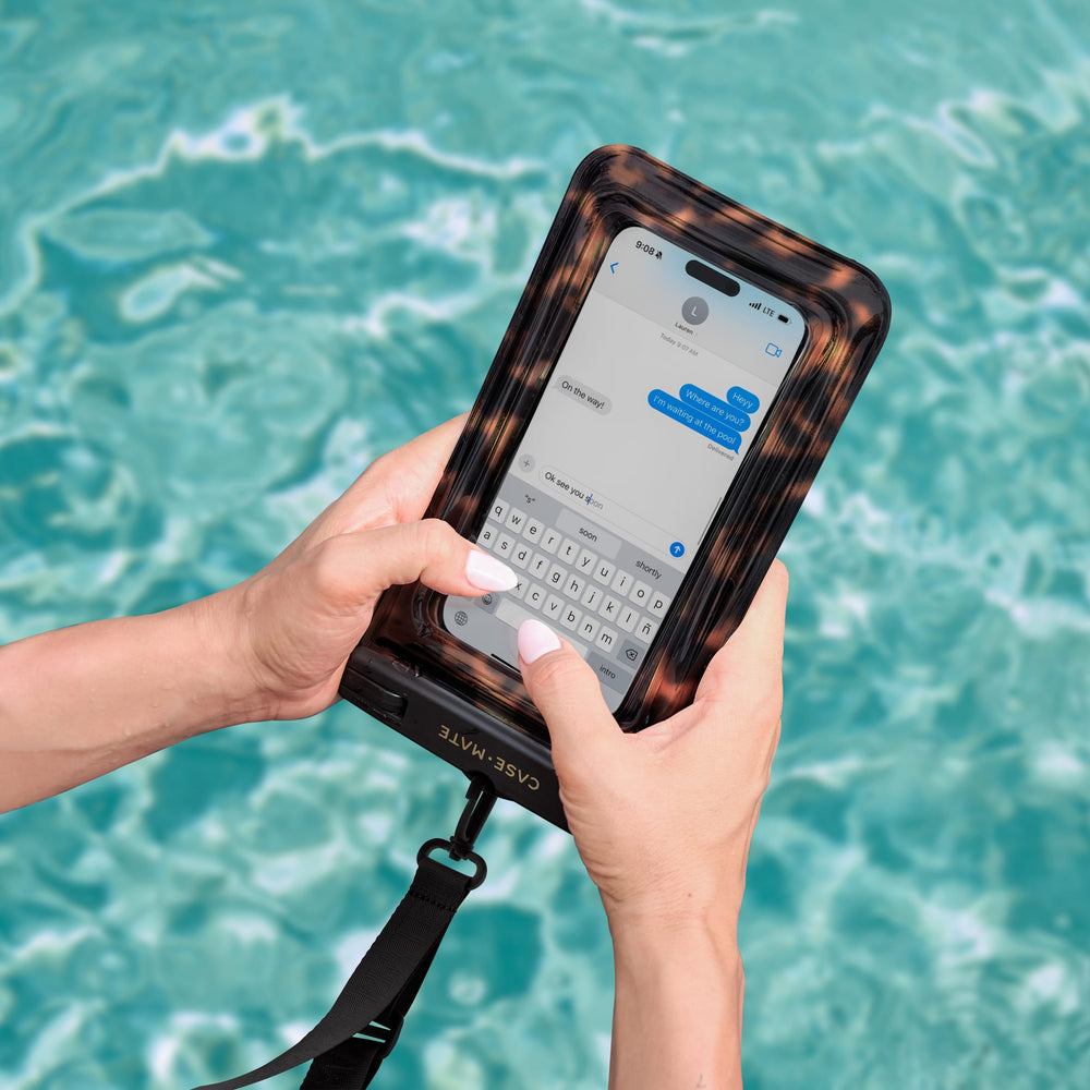 Person holding a phone with a water-resistant case over a pool #color_tortoiseshell