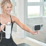 Woman holding a white mug and a smartphone with a clear case in an indoor setting.
#color_midnight black