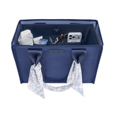 A navy blue fabric organizer bag with two handles, shown open to reveal storage compartments filled with travel accessories. The bag has a small 'LIVING LIFE' brand label on the front and a matching patterned scarf hanging from one of the handles against a plain white background.
#color_navy