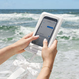 Person using a smartphone with a white case on a beach #color_ivory pearl bow
