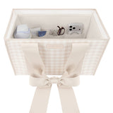 A cream-colored fabric organizer box with a gingham pattern and a large ribbon bow on the front, shown open with various small accessories stored inside against a white background.
#color_french vanilla