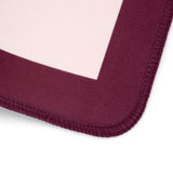 Close-up of a mouse pad corner showing a deep burgundy fabric border with a pale pink center on a white background.
#color_classic ballet pink