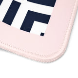 Close-up of a light pink stitched fabric item, likely a mouse pad or mat, showing a white section with bold navy geometric lettering on a white background.
#color_classic cabana stripe