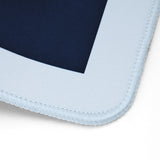 Close-up of a mouse pad corner showing a dark navy blue center surrounded by a wide light blue border with stitched edges on a white background.
#color_classic carolina blue