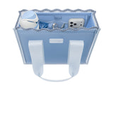 A light blue fabric tote bag with white handles, shown open to reveal its interior compartments containing a water bottle, phone, and other accessories.
#color_carolina blue