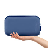 A navy blue zippered pouch held in a person's hand against a clean white background. The brand name 'CASE・MATE' is embossed vertically on the right side of the pouch.
#color_oxford navy