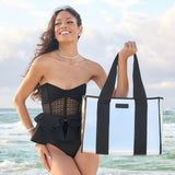 Woman at the beach in a swimsuite showing her Silver Chrome Jelly Tote Bag
#color_silver chrome