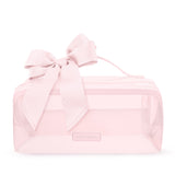 A light pink transparent zippered cosmetic bag with a large matching pink satin bow on top and a small rectangular brand plaque on the front.
#color_ballet pink bow