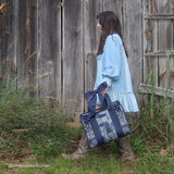 Woman walking in front of barn with a denim dress and boots with Jelly Tote in hand
#color_navy bandana bow