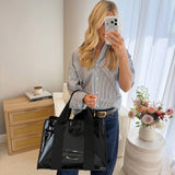 Woman posing in front of mirror showing her midnight jelly tote bag
#color_midnight black