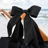 Close up of the bow detail on the Midnight Black Bow Tote on the beach #color_midnight black bow