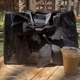 @lizapaigewears Bow tote on table next to an iced coffee. #color_midnight black bow