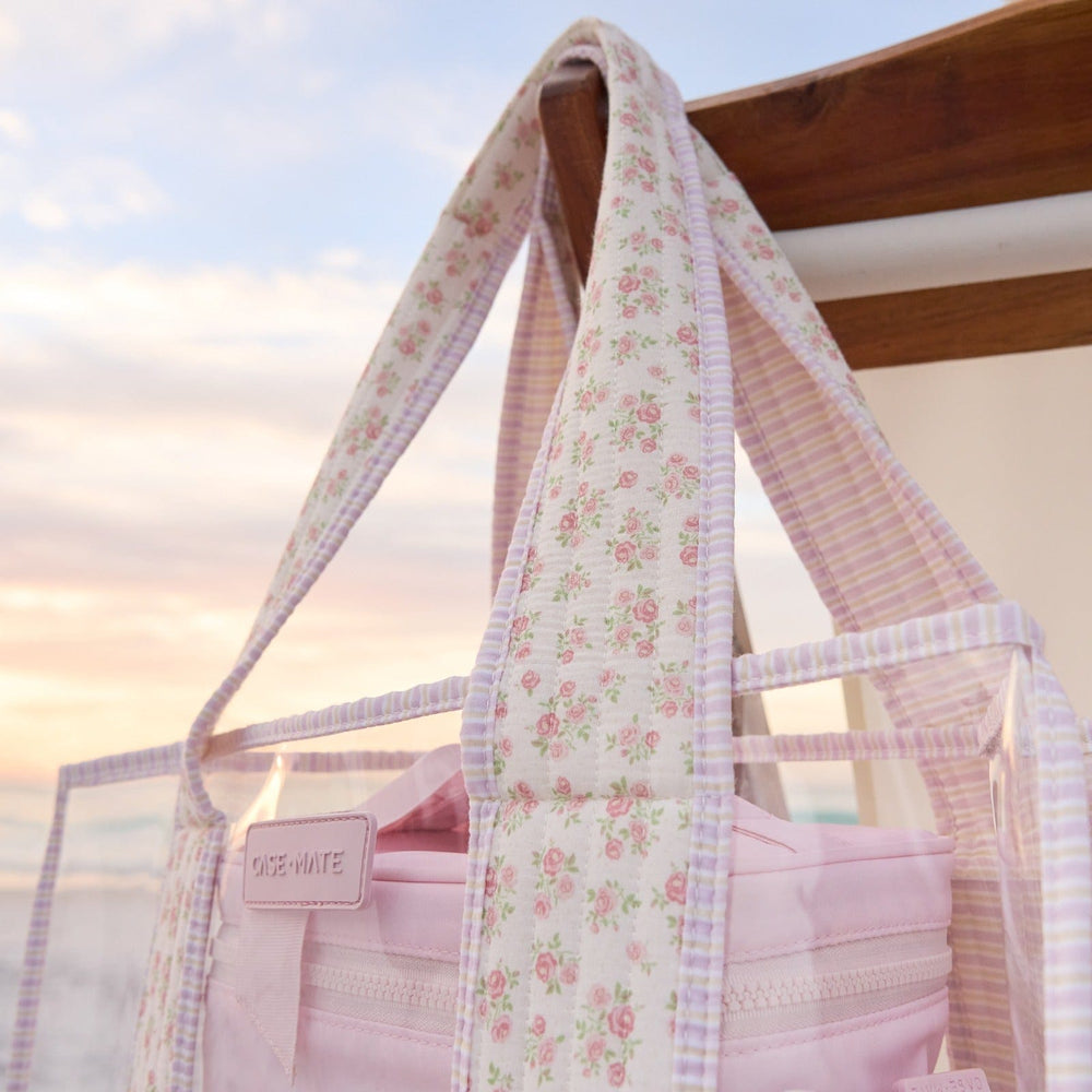 Floral-patterned bag with a visible brand logo against a blurred natural background
#color_quilted ditsy floral
