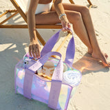 Soap Bubble Jelly Tote filled with towels and beach related items on the sand next to beach chair.
#color_iridescent