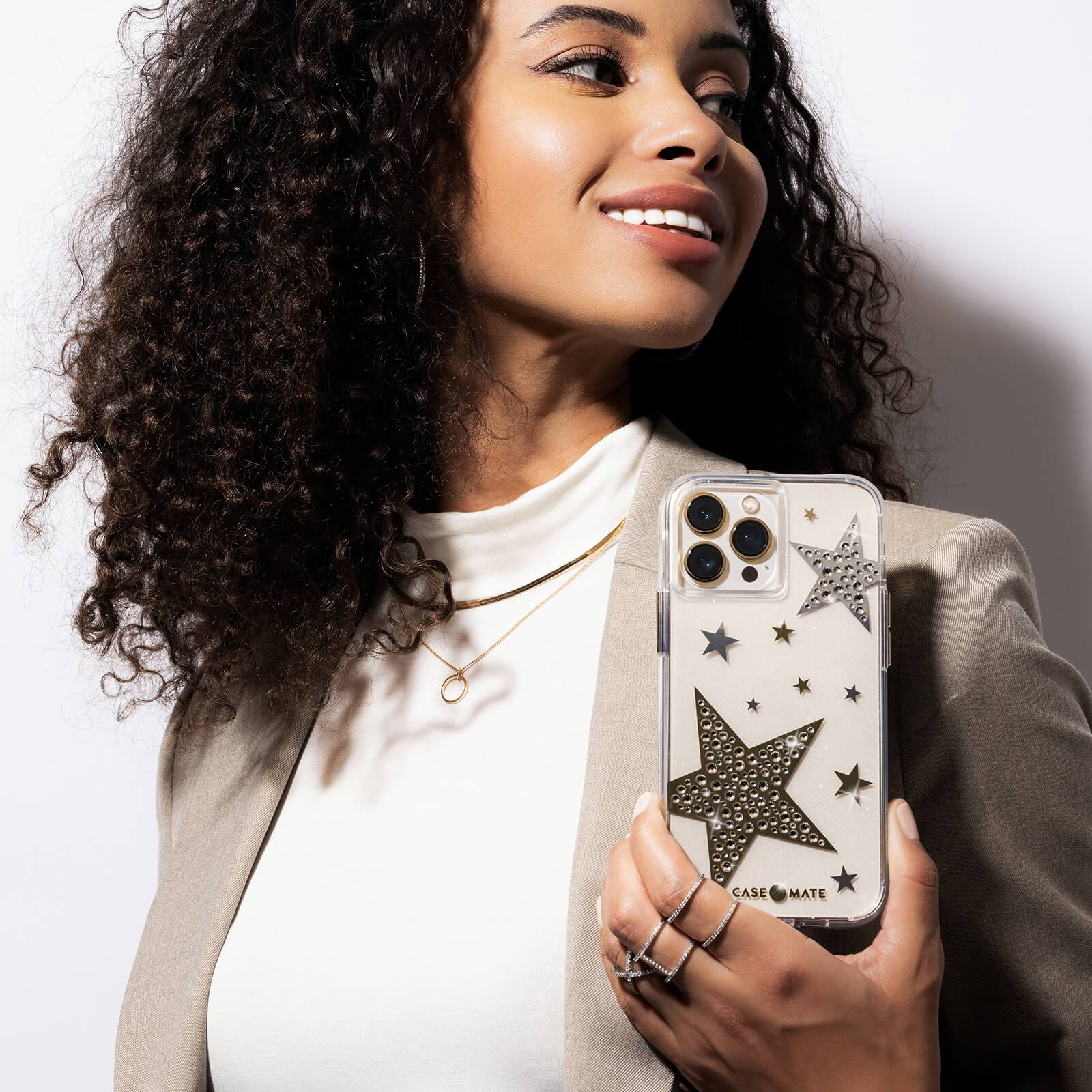Woman holding sheer phone case case with sparkly stars and gems. color::Sheer Superstar