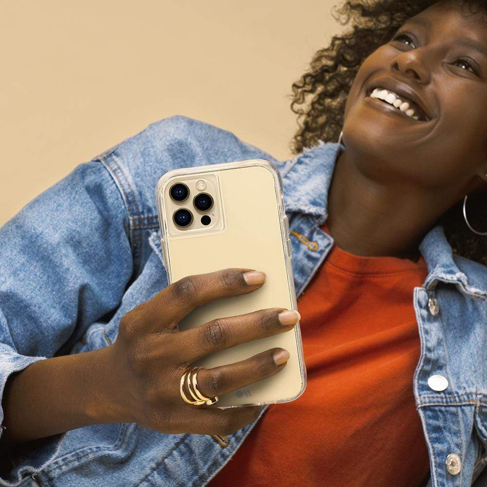 Woman holding Tough Clear case. color::Clear