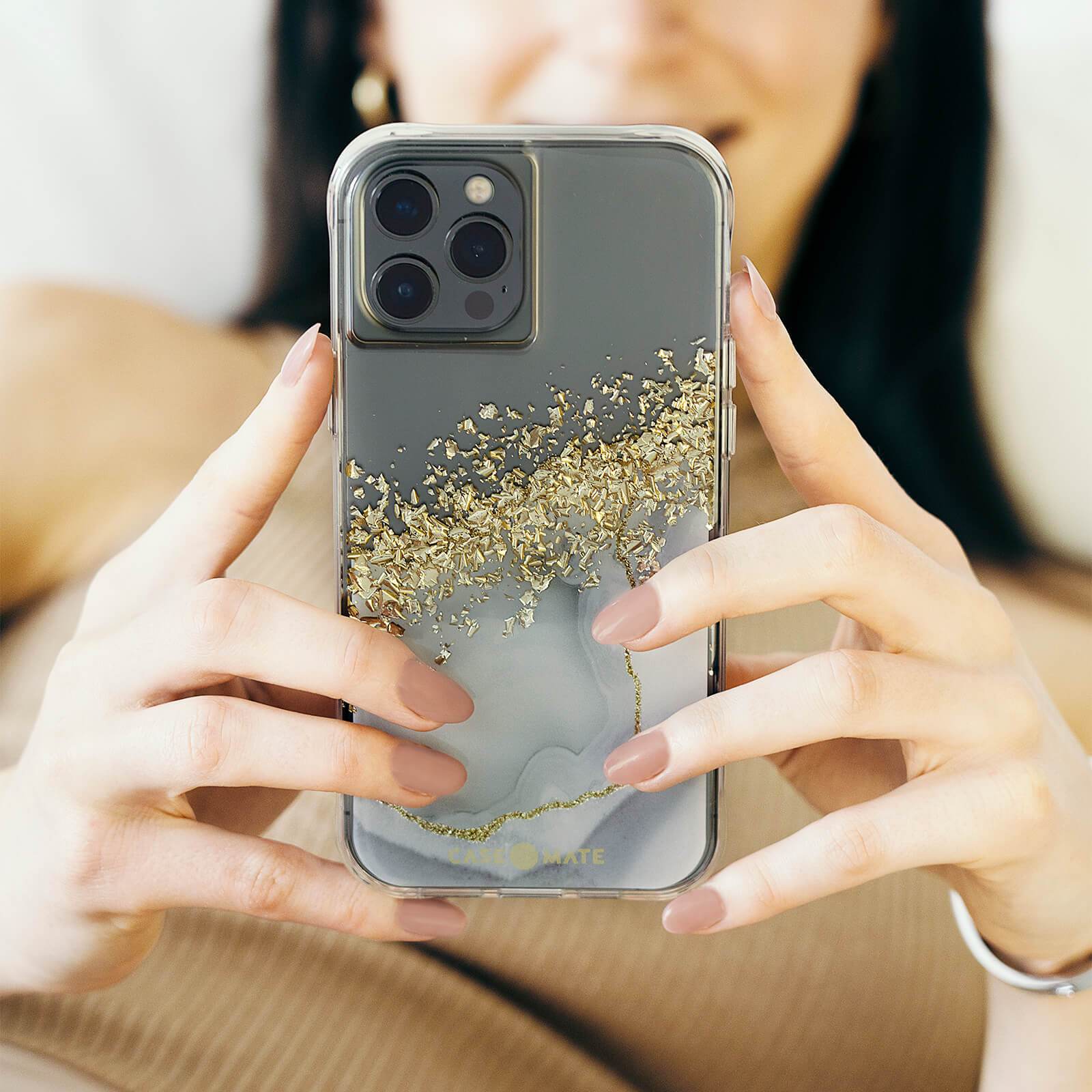 Woman holding fashion marble iPhone 11 Pro Max case. color::Karat Marble