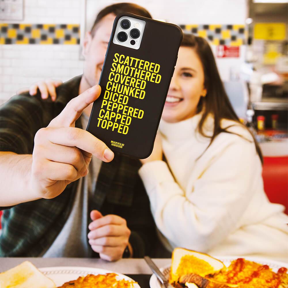 Man and woman taking selfie with hashbrowns case. color::Hashbrowns Black