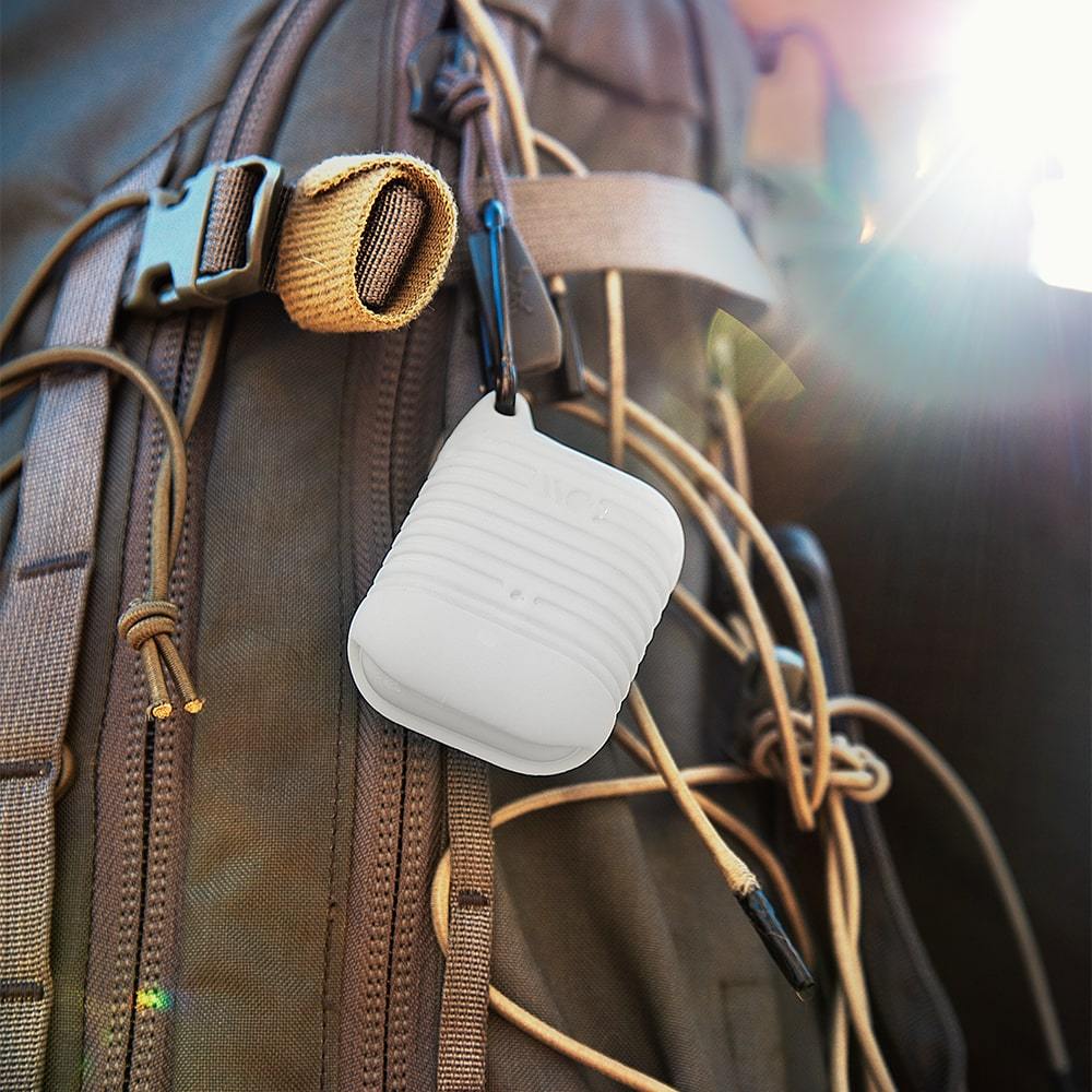AirPods case hooked to backpack. color::White