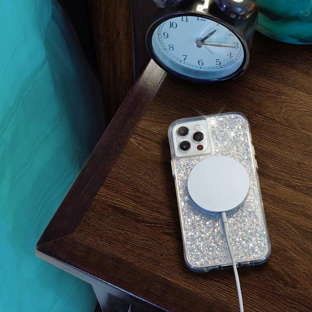 Twinkle MagSafe charging on bedside table. color::Twinkle Stardust