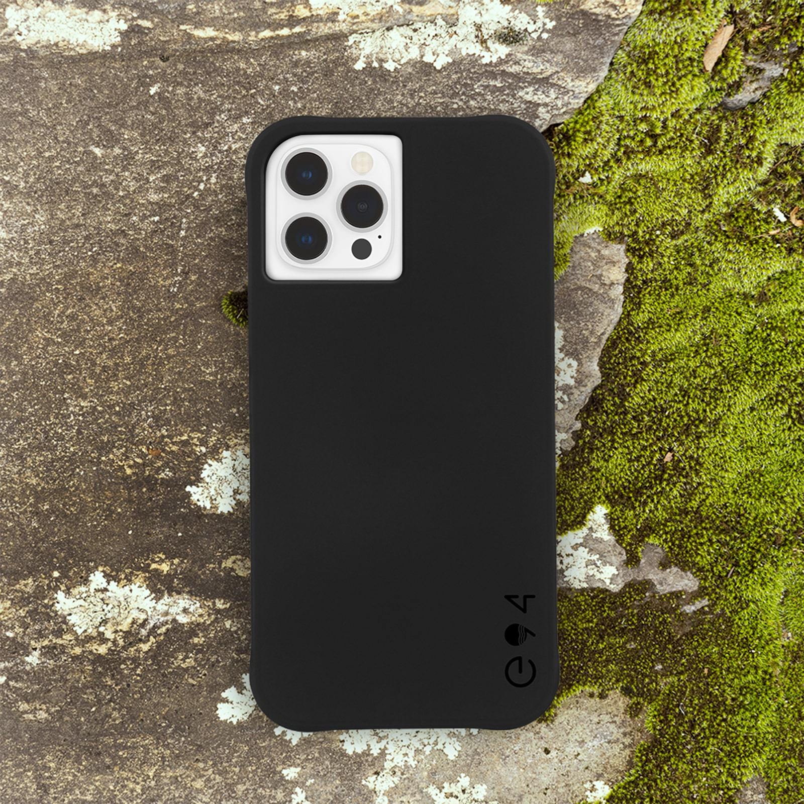 Black recycled iPhone 12/ iPhone 12 Pro case sitting on mossy rock. color::Black