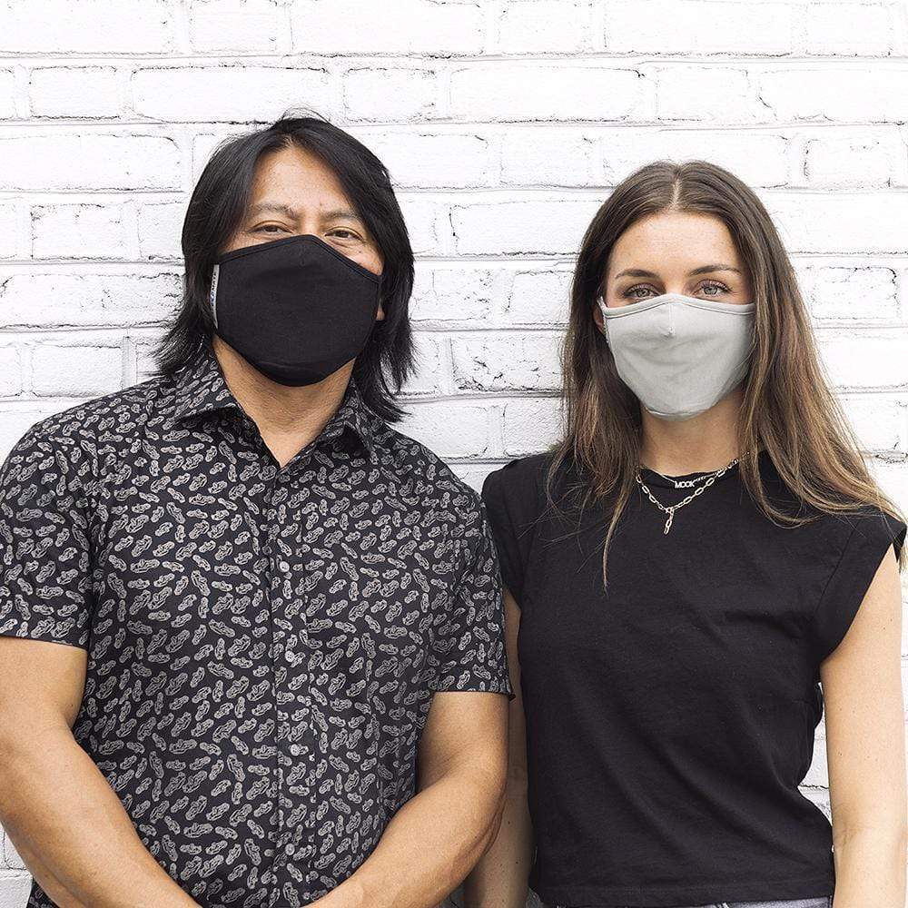 Man wearing black cloth face mask and woman wearing gray cloth face mask. color::Multicolor