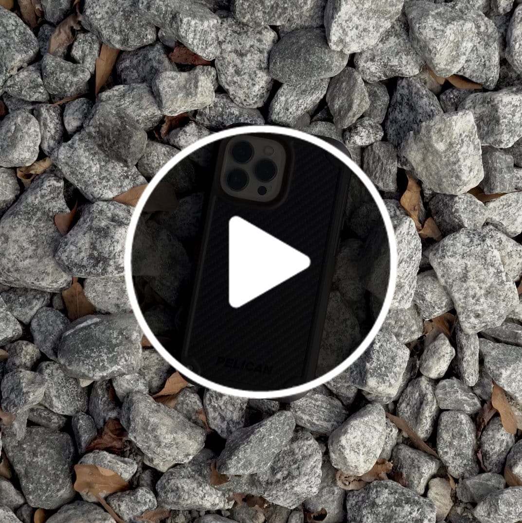 Pelican Shield Kevlar sitting on a pile of rocks. color::Black https://cdn.shopify.com/s/files/1/0347/8496/8840/files/ppv_iPhone_13_Shield_Kevlar_PP046614.mp4?v=1637011517