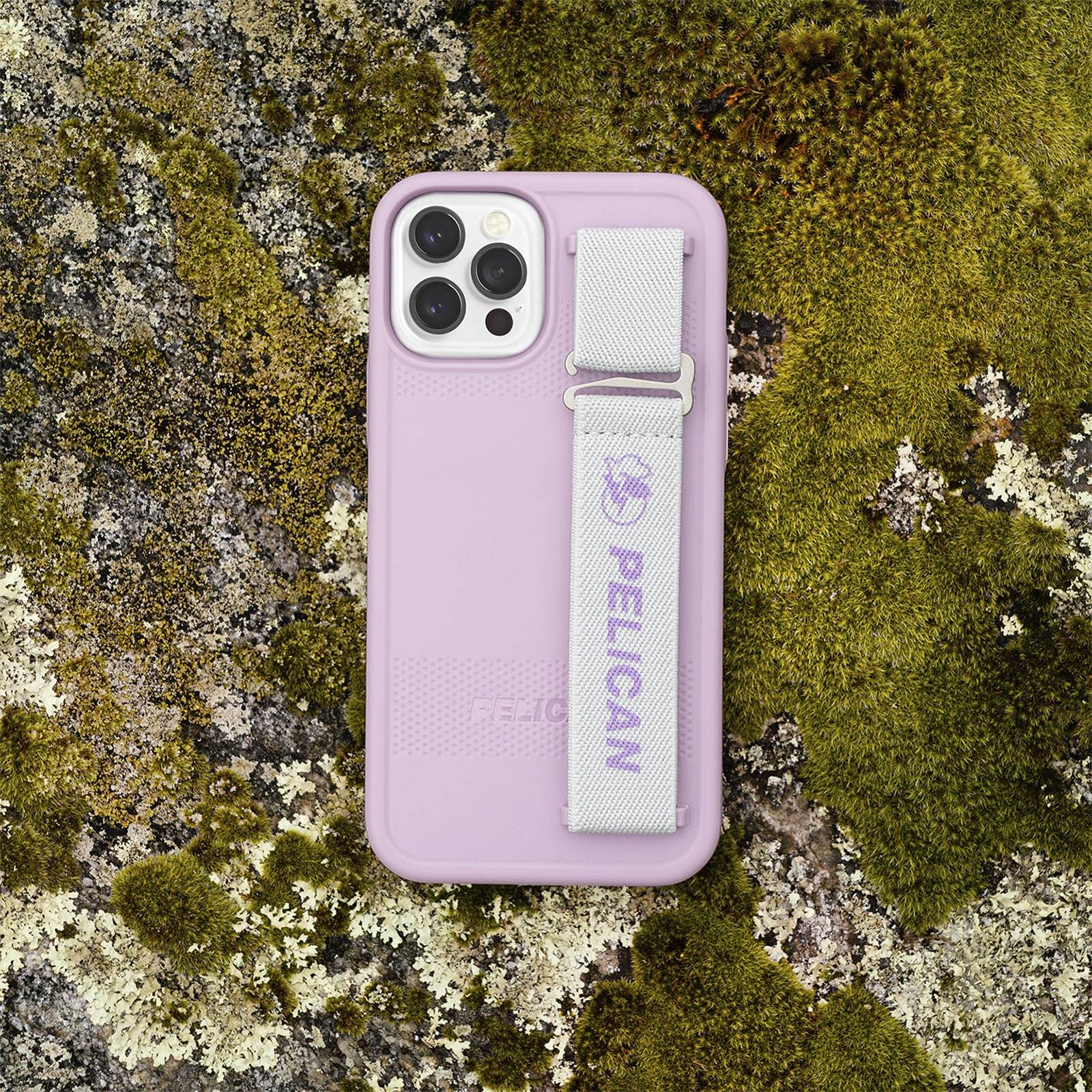 Pelican Protector Sling on mossy rock. color::Mauve Purple