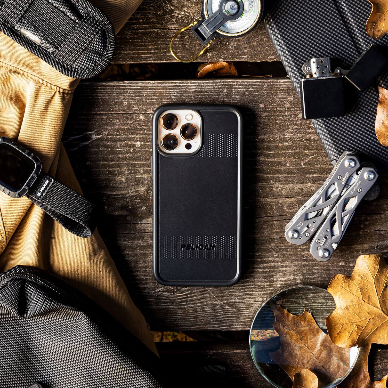 Black Pelican Protector surrounded by outdoor tools and gear. color::Black