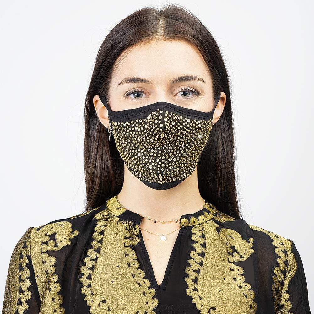 Woman wears adjustable gold face mask. color::Gold