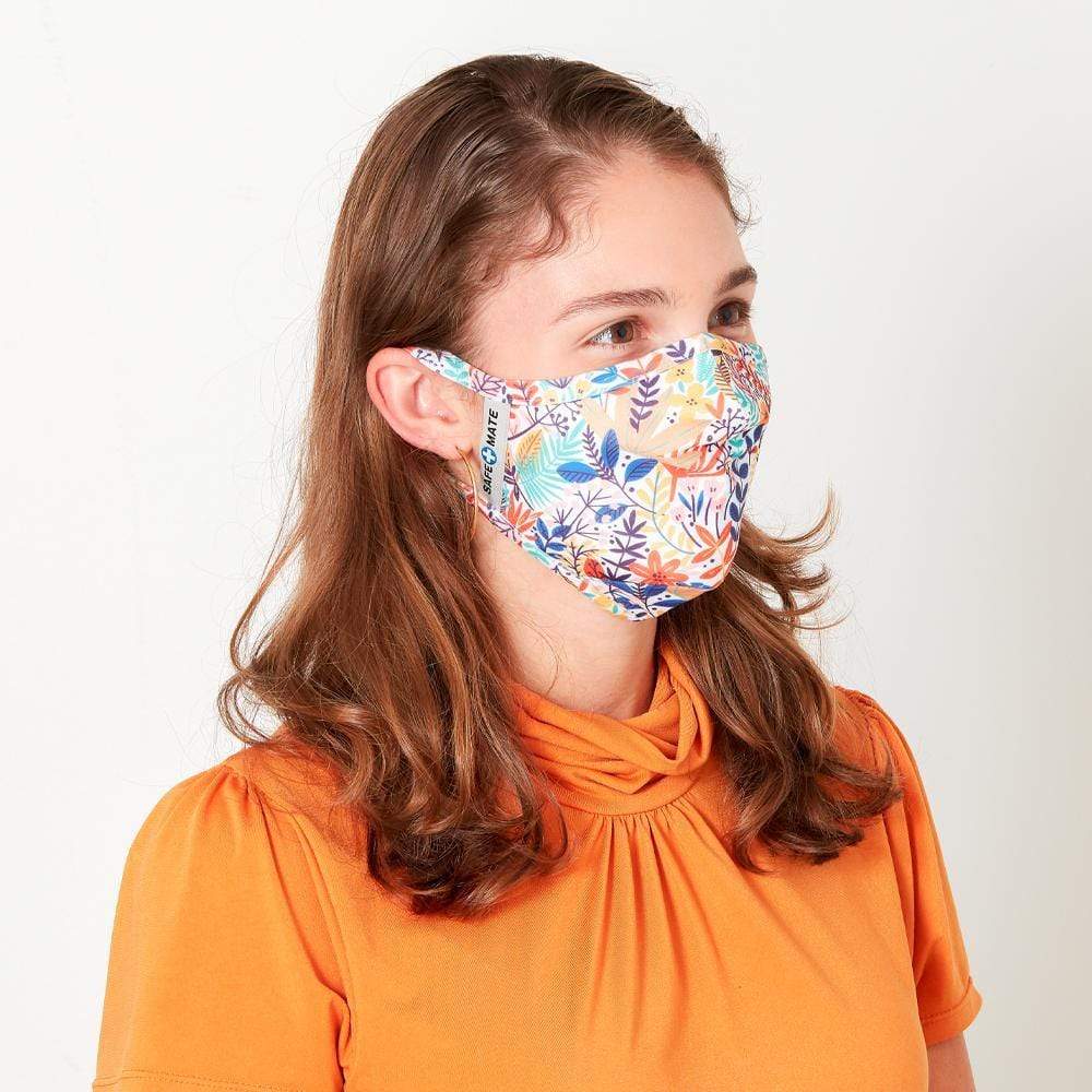 Woman wearing bright pattern fashion face mask. color::Ferns