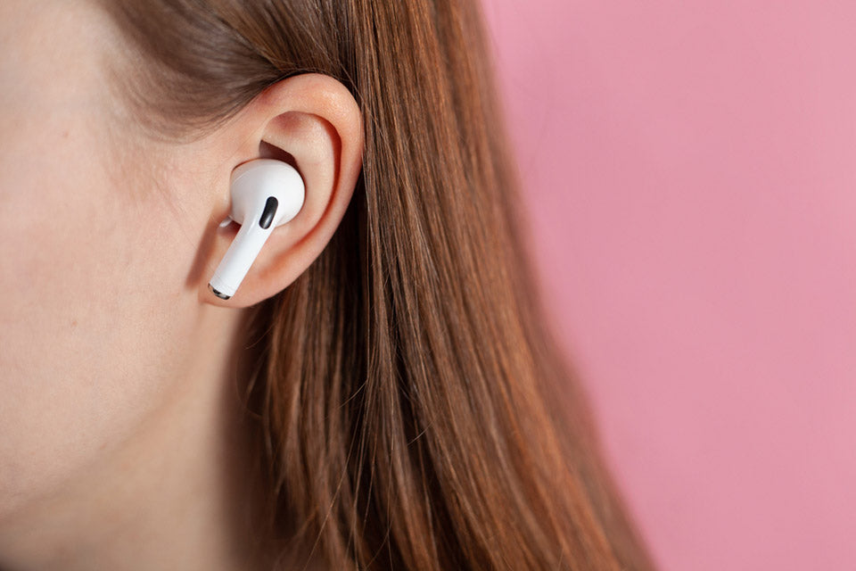 girl uses wireless white headphones