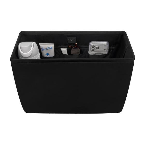 Black storage ottoman with various items on a white background
#color_midnight black