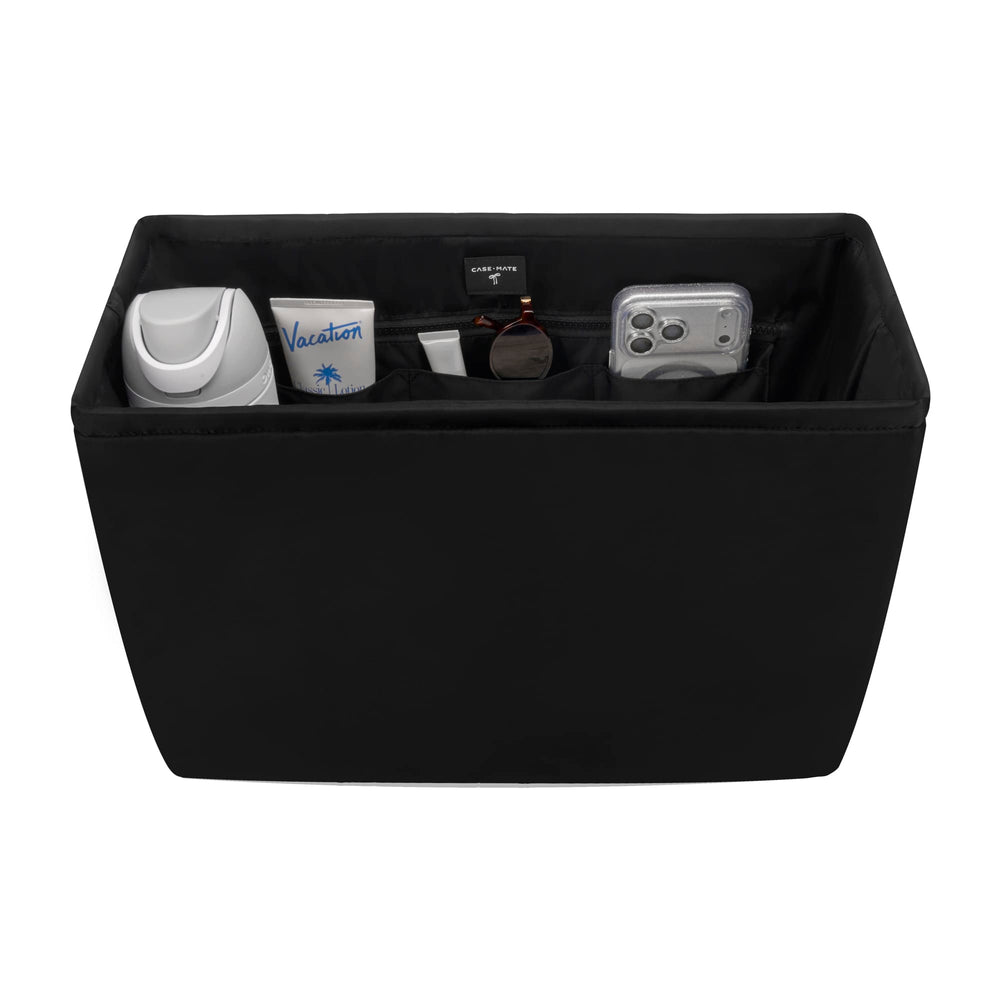 Black storage ottoman with various items on a white background
#color_midnight black