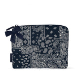 A navy blue and white paisley bandana-patterned zippered pouch with a matching navy bow on the zipper pull, shown on a plain white background.
#color_navy bandana bow