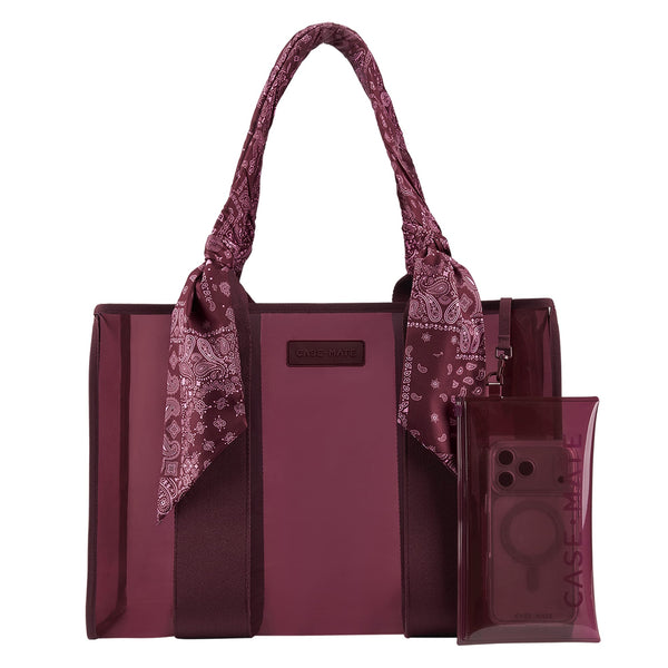 A burgundy tote bag with matching translucent phone pouch and a paisley scarf tied to the handles, shown on a plain white background. 

#color_mulberry twilly