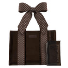 A brown tote bag with white polka-dot handles and a matching clear phone case with a large bow, both branded CASE-MATE, shown on a plain white background.
#color_espresso polka dot bow