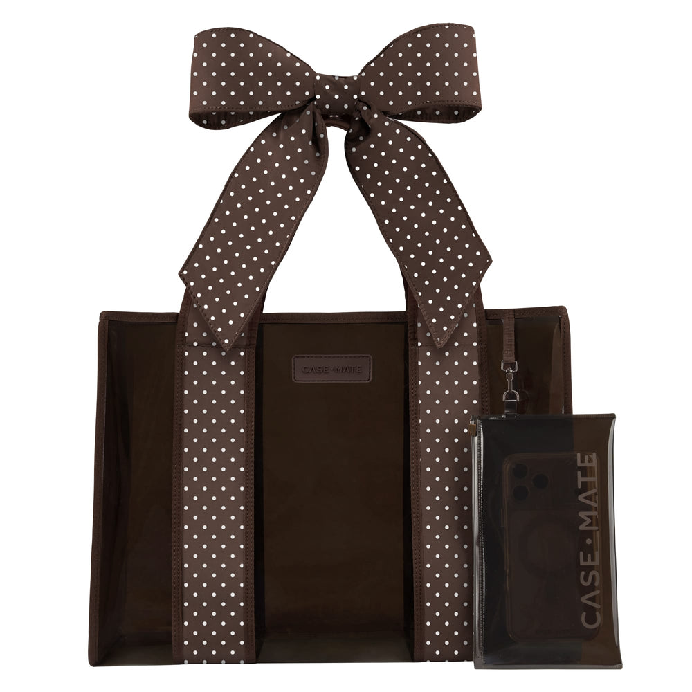 A brown tote bag with white polka-dot handles and a matching clear phone case with a large bow, both branded CASE-MATE, shown on a plain white background.
#color_espresso polka dot bow