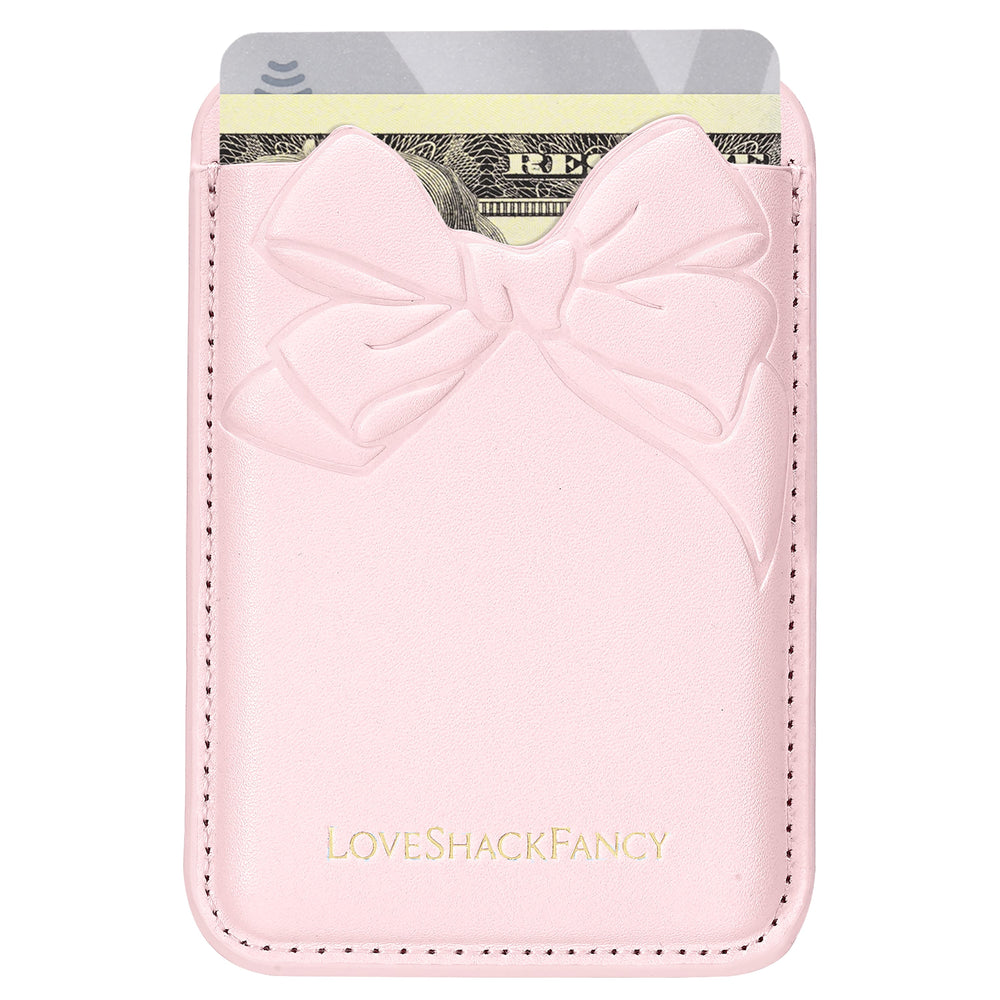 Pink cardholder with a bow design featuring 'LOVE SHACK FANCY' 
branding.
#color_pink