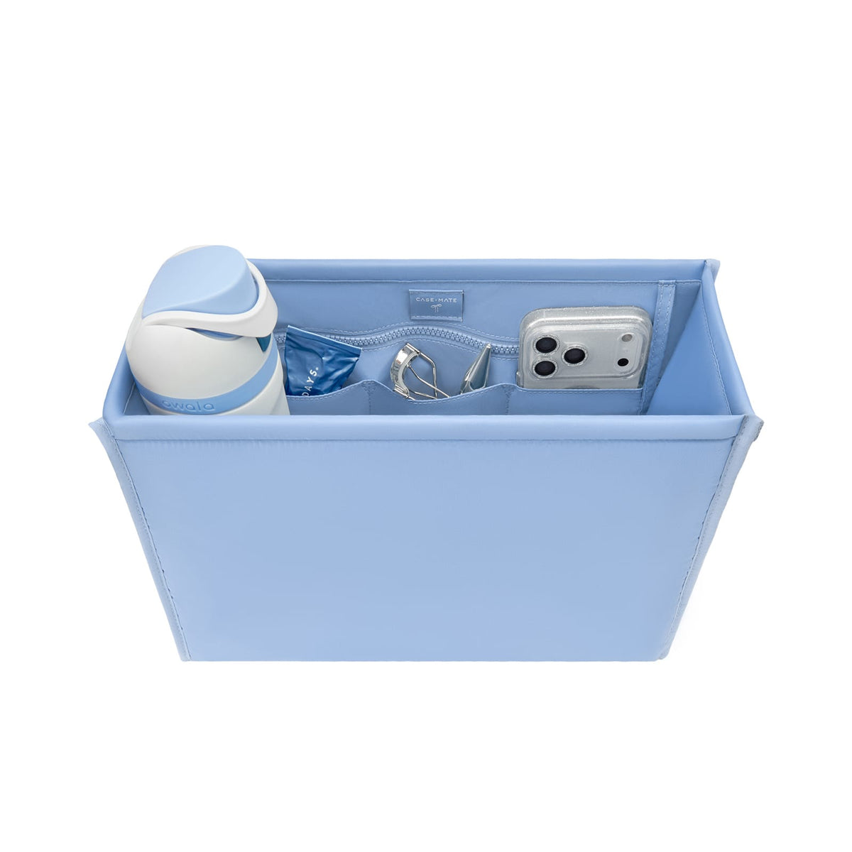 A light blue rectangular organizer tray with interior zippered compartments, shown holding a white and blue bottle, a small blue item, a silver ring, and a silver smartphone. The organizer is photographed on a clean white background. 

#color_carolina blue