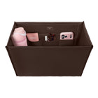 A brown fabric organizer bag with multiple interior pockets, shown from above on a white background. The organizer is styled with various pink and neutral accessories, including a pink bottle, a pink pouch, and a pink smartphone.

#color_espresso