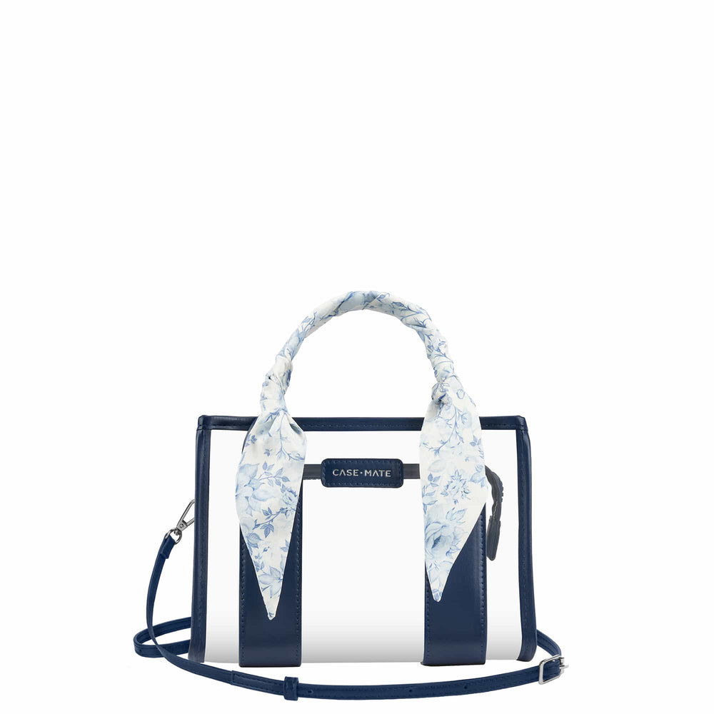 A Case-Mate structured handbag with navy blue and white vertical stripes, featuring a light blue and white floral silk scarf tied to the top handle, set against a plain white background.

#color_something navy twilly