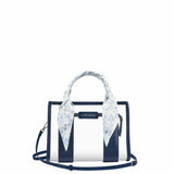 A Case-Mate structured handbag with navy blue and white vertical stripes, featuring a light blue and white floral silk scarf tied to the top handle, set against a plain white background.

#color_something navy twilly
